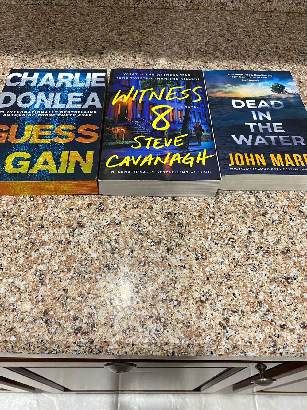 3 paperback books 
Witness 8, Guess Again and Dead in the Water
